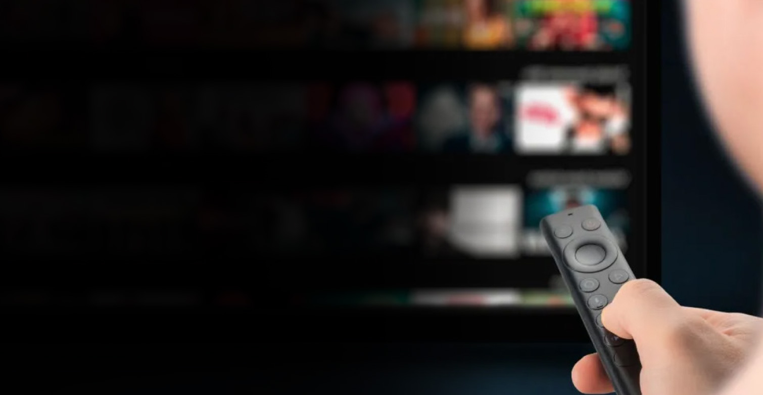 Person using TV control to change content