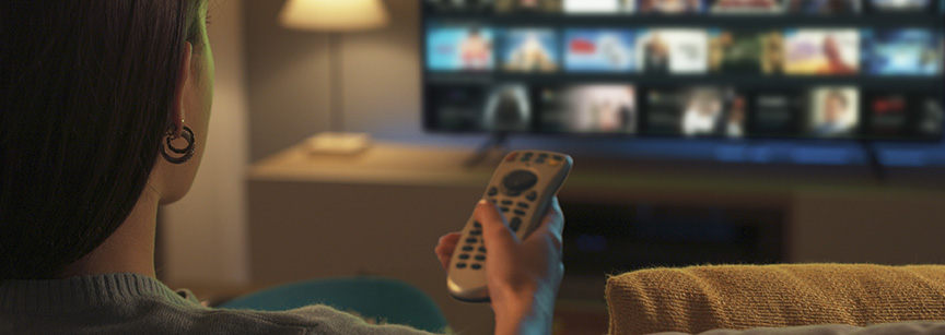 Person using TV control to change content